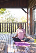 © Wavebreak Media - Senior woman meditating on yoga mat at log cabin deck, enjoying tranquility, copy space