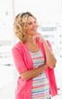 © Wavebreak Media - Smiling businesswoman in colorful outfit thinking creatively in bright office