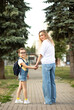 © zulfiska - Woman mother and her charming little daughter. Mom leads little school child first day at school.