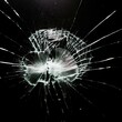 © Pablo - Broken glass with central impact and radial cracks on a black background, highlighting details of the fractured crystal. Shattered glass texture with light effects on the cracks