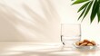 © Nice Seven - A minimalist scene featuring a glass of water next to a plate of almonds, with a green plant adding a touch of nature, ramadan fasting  purity gratitude eid ul fitr mubarok