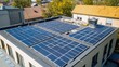 © Sampao - Solar panel installation on a commercial building rooftop in an urban setting.