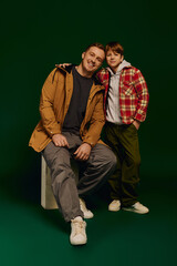 Wall Mural - Father and son enjoying a joyful moment in casual studio fashion photography together