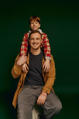 Wall Mural - Joyful moments shared between father and son in a casual studio setting