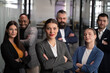 © HudHudPro - Confident business team standing with crossed arms in modern office, looking at camera. Concept of leadership, teamwork, corporate success, diversity, and professional collaboration