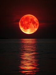 Wall Mural - Fiery moonrise over tranquil sea with vibrant reflections casting a warm glow on the water surface creating a dramatic and serene nocturnal seascape