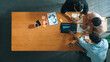 © Summit Art Creations - Executive manager explain financial graph to colleague at meeting room. Top aerial view of diverse marketing team sharing idea and planning strategy while sitting at table with tablet. Convocation.