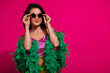 © deagreez - Attractive young woman in stylish attire posing against a vivid magenta background, exuding charm and glamour during a celebration