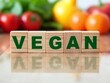 © Michael - Wooden cubes showing vegan lifestyle with vegetables in background