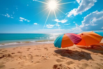 Wall Mural - A bright, sunny day at the beach with two colorful umbrellas on the sandy shore, Bright sun shining on a sandy beach with colorful umbrellas