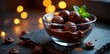 © dadtophoto - Luxurious dark chocolate in a sleek glass bowl with fairy lights, modern decor,