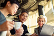 © Marko Geber - Diverse business team collaborating in modern cafe
