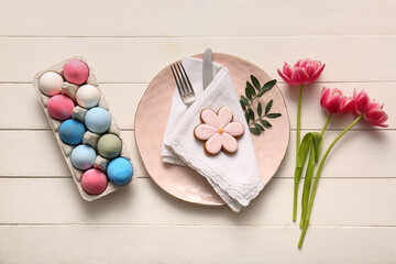 Canvas Print - Beautiful table setting with sweet cookie, Easter eggs and tulip flowers on white wooden background