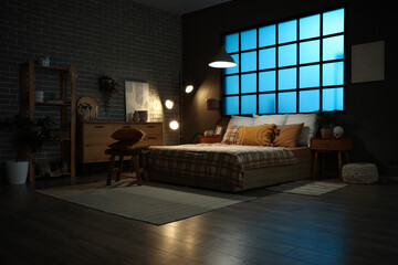 Canvas Print - Big comfortable bed and bedside tables in interior of bedroom at night