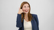 © HI Pictures - In a studio setting, a young businesswoman wearing a suit is standing in front of a white background, placing her hand near her ear to make a 'call me' gesture and looking at the camera
