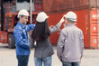 © Wosunan - Container manufacturing manager and businesswomen survey the area to plan the storage and moving of goods in and out of the container storage area