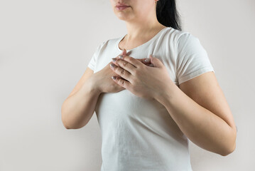 woman in white t-shirt suffers from heart pain. Heart pain.