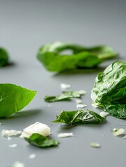 Poster - Fresh green spinach leaves scattered on a smooth gray background highlighting their natural texture and color : Generative AI