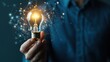© PengAI - A person holds a glowing light bulb, symbolizing ideas, innovation, and creativity, set against a dark background with a digital network effect.