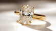 © ABC IMAGE - A close-up of a gold engagement ring with a large oval diamond at its center, set on a white surface