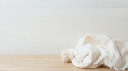 Poster - Soft white blanket casually draped on a wooden surface creating a serene atmosphere : Generative AI