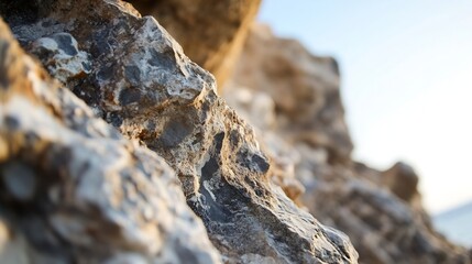 Poster - Detailed view of rough rocks with sunlit texture and blue sky : Generative AI