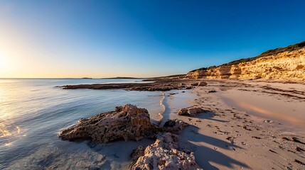 Canvas Print - Gorgeous sunset view over a tranquil beach with rocky shoreline and clear ocean waters : Generative AI