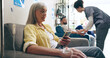 © peopleimages.com - Hospital, phone and mature woman in chemotherapy for cancer treatment, medication and IV drip of medicine. Healthcare, clinic and person on smartphone for social media, website and internet news