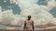 © Reyhan - Man stands looking up at the fluffy clouds in the sky