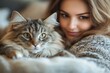 © ChaoticMind - Woman cuddling her fluffy cat indoors in a cozy, soft setting during the daytime