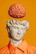 © VISTA by Westend61 - Surreal collage of a classical bust with a floating brain on a yellow background