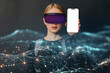 © VISTA by Westend61 - Person using VR glasses and holding a smartphone with a digital interface