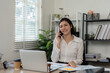© itchaznong - Accountant on a phone call discussing financial strategies in the office.