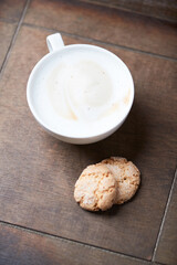 Wall Mural - Cappuccino on dark wooden background. Soft focus. Close up.	