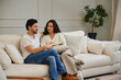 © callisto - Cozy couple reading together on a comfortable sofa at home