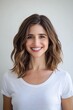 © felix_brönnimann - Smiling woman portrait with healthy hair in casual white t-shirt on plain background showcasing happiness and confidence in lifestyle photography.