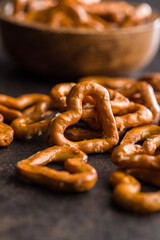 Canvas Print - Heart shaped pretzel on black table.