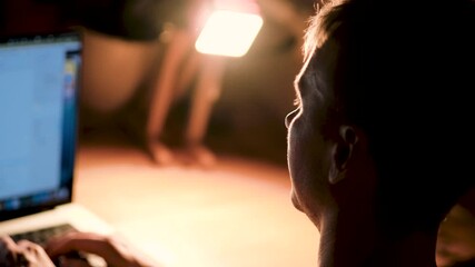 Canvas Print - close-up of a man's face in a dark room looking at a monitor screen