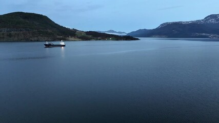 Wall Mural - view of a cargo vessel transiting through the Gjemnessundet sound near the city of Kristiansund