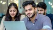 © Teedanai - Focused Young Adults Collaborating on Laptop in Modern Office
