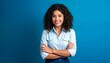 © KarpenArt Studio - A young woman with curly hair and a light blue shirt is smiling at the camera.