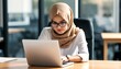 © KarpenArt Studio - two muslim women wearing hijabs working on a laptop.