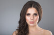 © yellowj - studio photo of a brunette on a gray background