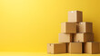 © PNG HAP HAP - A stack of cardboard boxes on a yellow background, a concept for online shopping and moving house, with blank space for text or design