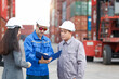 © DG PhotoStock - Businesswoman and logistic or shipyard engineer have a discussion or business due at container yard.