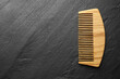© New Africa - One wooden hair comb on grey background, top view. Space for text