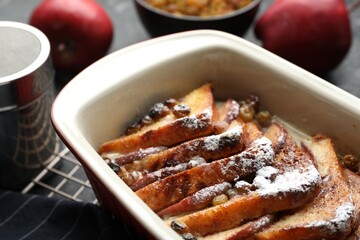 Wall Mural - Freshly baked bread pudding in baking dish on table, closeup