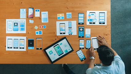 Wall Mural - top view of skilled developer walking and placing ux ui software. smart business man put tablet on m