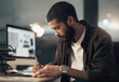 © N F/peopleimages.com - Writing, creative and man in office, night and employee with ideas for project, computer and web designer. Overtime, notes and working late for deadline in business, person and planning for design
