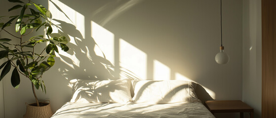 Poster - Cozy bedroom with sunlight streaming through window, illuminating bed and plant